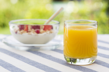 Fresh orange juice and bowl of muesli