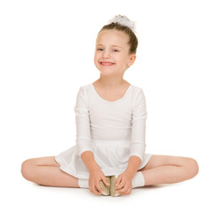 little girl dancing in a white ball gown