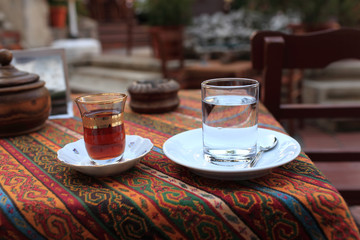 Cup of turkish tea and glass of water
