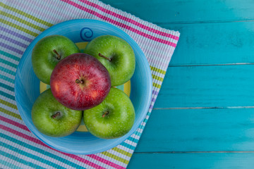 Farm fresh organic  apples on wooden retro blue table background