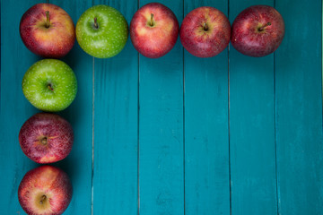 Farm fresh organic red and green apples on wooden table
