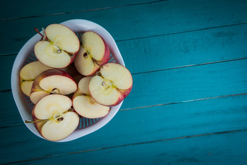 fresh organic apples halves on wooden kitchen table background