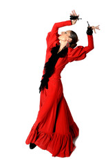 young Spanish woman dancing flamenco with castanets in her hands