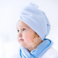 Litlte girl in a bathrobe and towel