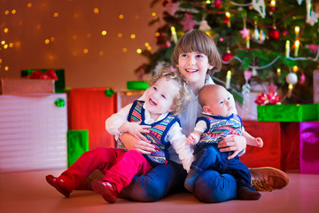 Fototapeta na wymiar Children under a Christmas tree