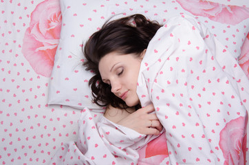 Girl covered with a blanket in bed