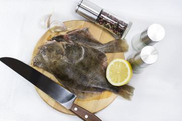 raw fish on a cutting board and knife