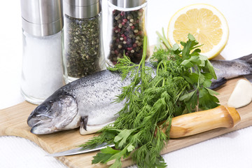 raw fish on a cutting board and knife