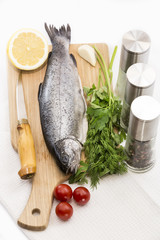 raw fish on a cutting board and knife