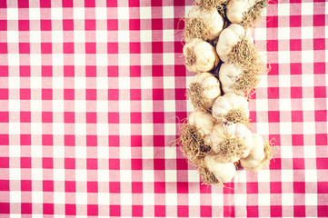 Rustic garlic on a red and white  tablecloth 