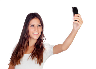 Fototapeta premium Attractive casual girl taking a photo with her mobile