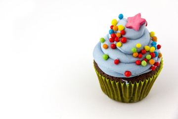 cupcake with blueberry frosting and colorful sprinkles