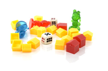 Toy houses puppets and dice on a white background