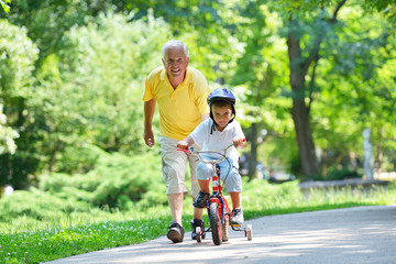 happy grandfather and child in park