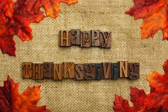 Happy Thanksgiving mesage on burlap with leaves