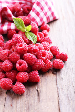 Ripe sweet raspberries on table close-up