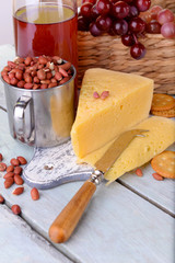 Wine, cheese and crackers on wooden table close-up