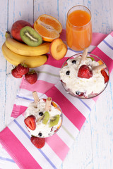 Fresh fruits salad with ice cream in bowls and juice