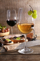 beautiful still life with wine, cheese and ripe grape