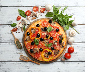 Delicious pizza served on wooden table