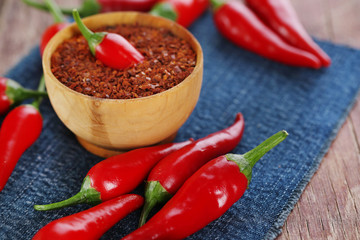 Red hot chili peppers and milled pepper in bowl