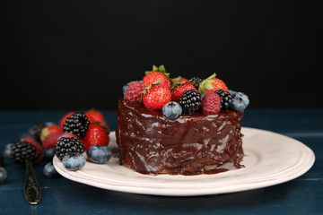 Tasty chocolate cake with different berries