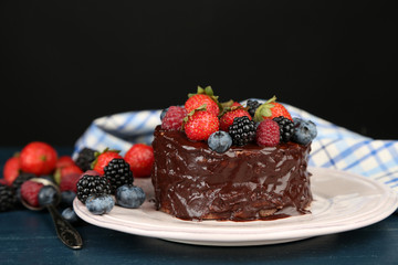 Tasty chocolate cake with different berries