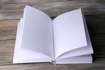 White book on wooden table, close-up
