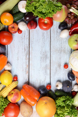 Fresh organic fruits and vegetables on wooden background