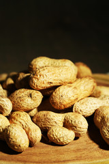 Peanuts in bowl on rustic wooden background