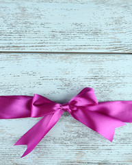 Old wooden background with beautiful bow