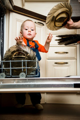 Baby helping unload dishwasher