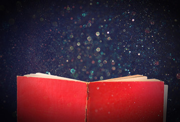 open red book and glowing glittering lights