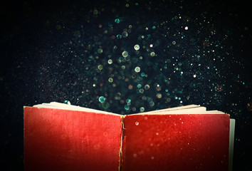 open red book and glowing glittering lights