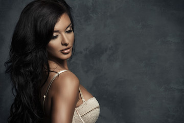 Fashionable young brunette sensual woman posing.