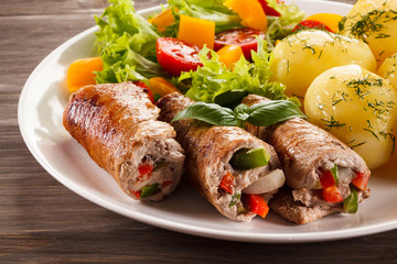 Wrapped pork chop, boiled potatoes and vegetables