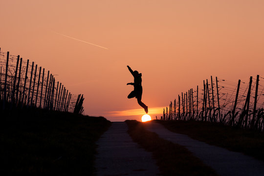 man jumping in sunset