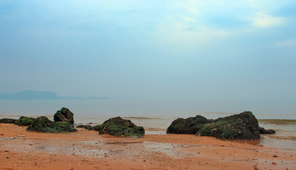 Fototapeta na wymiar Beach with stones in the background haze