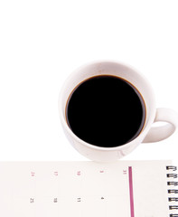 A mug of coffee and table day planner