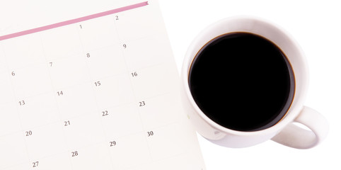 A mug of coffee and table day planner