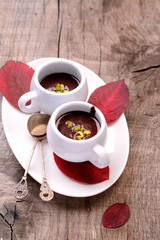 flavored hot chocolate in small ceramic chashkahna wooden table