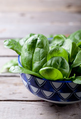 Baby spinach in a blue ceramic bowl