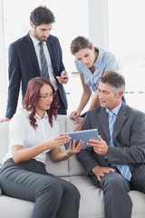 Business team looking at a tablet