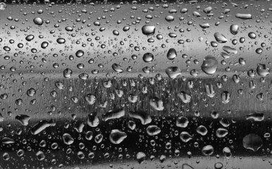Stainless steel with water drops on the rounded surface.