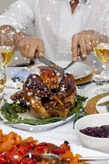 Close up of a man cutting a turkey for christmas dinner