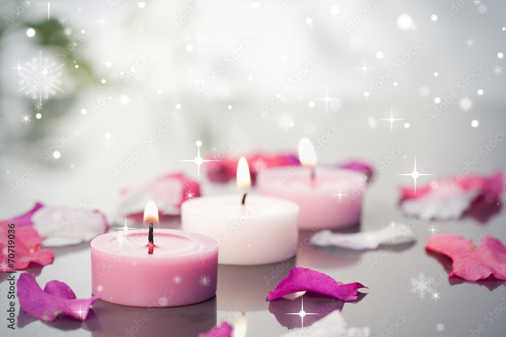 Poster composite image of lighted candles and petals
