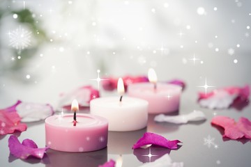 Obraz na płótnie Canvas Composite image of lighted candles and petals