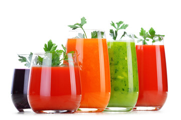 Glasses with fresh vegetable juices isolated on white