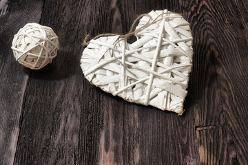 Romantic, white heart and sphere on dark wood - 70720042