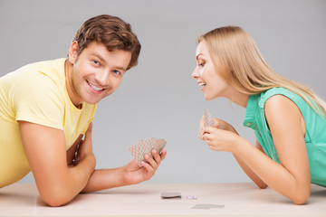Happy couple playing cards